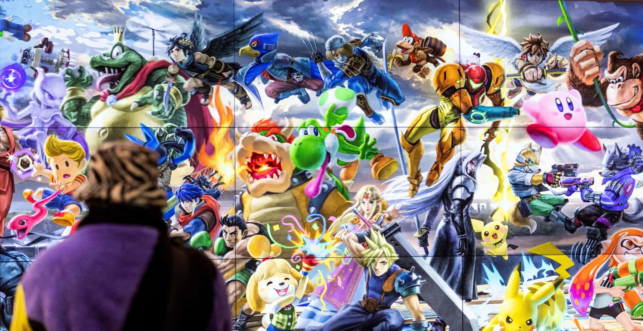 A person walks past a screen displaying characters of different Nintendo games at a store for Japanese games giant Nintendo in Tokyo on February 3, 2022. 