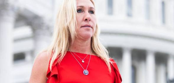 Marjorie Taylor Greene wears a red sleeveless top with little ruffles and two silver necklaces as she stands House steps of the US Capitol