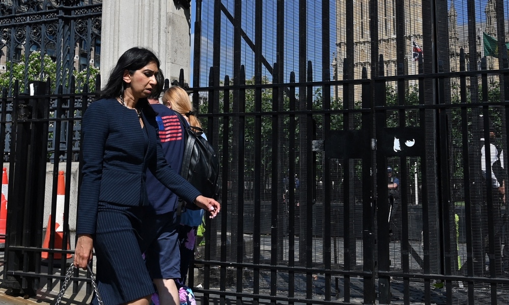 Attorney General Suella Braverman walks past the Houses of Parliament 