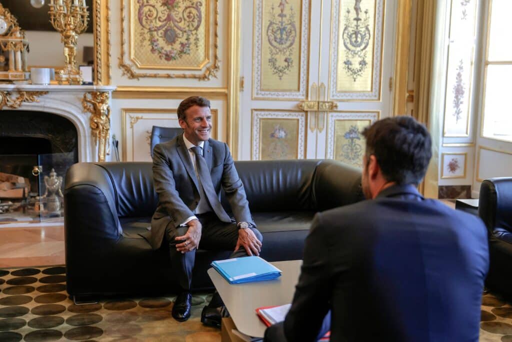France's President Emmanuel Macron (L) poses with Head of Paris 2024 Olympics Tony Estanguet (R) during a meeting at the Elysee Palace in Paris, on July 25, 2022.