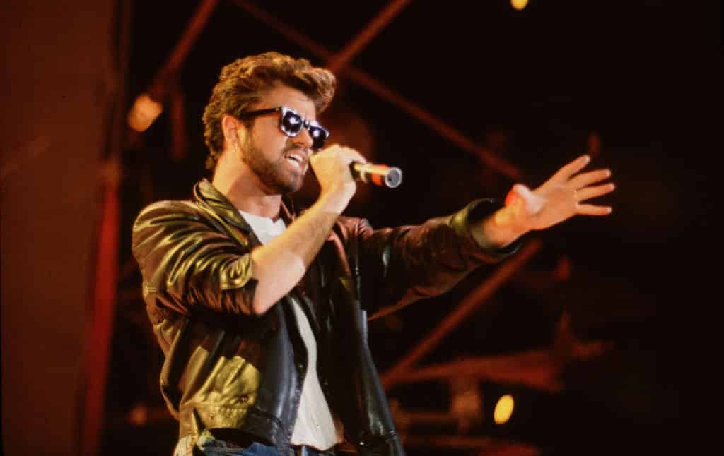 George Michael (1963 - 2016), of the group Wham, performs at Live Aid. 