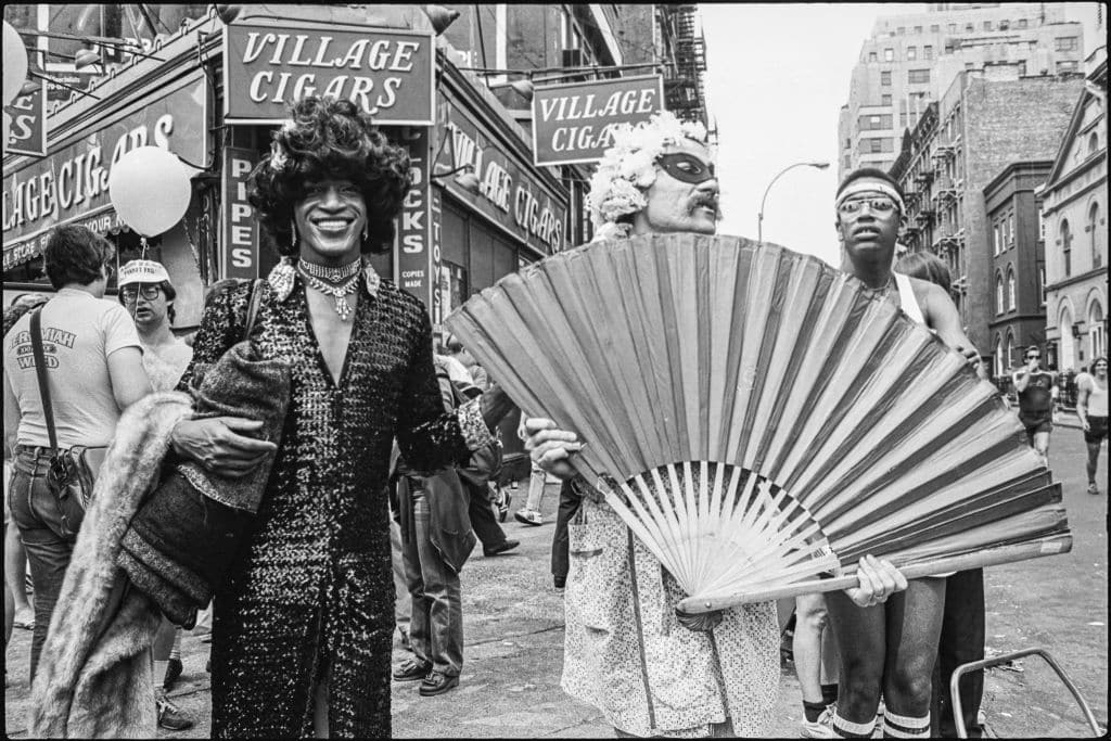 Marsha P Johnson (centre left, in dark outfit and black hair), along with unidentified others, on the corner of Christopher Street in 1982. 