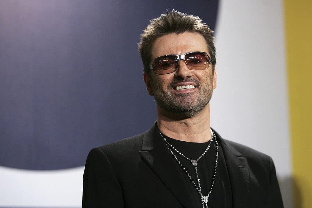 George Michael poses at the "George Michael: A Different Story" Photocall. 