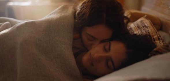 Tanya Reynolds and Seyan Servan as Helen and Nour in The Baby in bed together. (HBO/Sky)