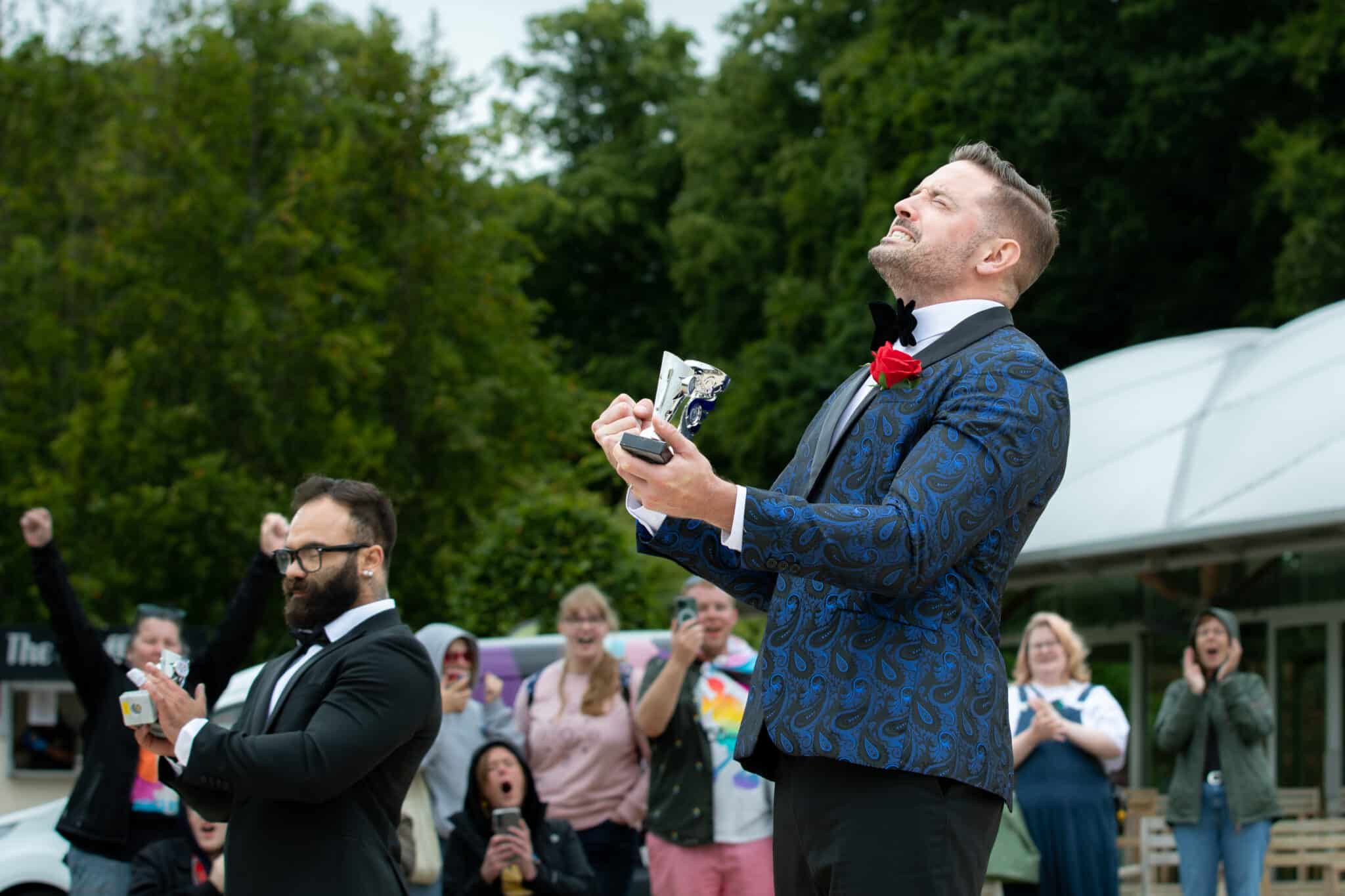 Paul Dennison holds up Mr Gay Europe trophy