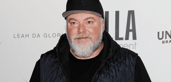 Kyle Sandilands stands for a red carpet photoshoot.