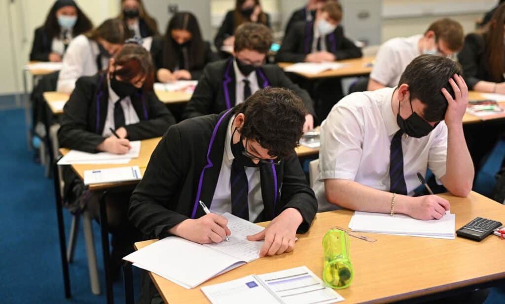 A classroom full of students prepare for take their exams in the UK