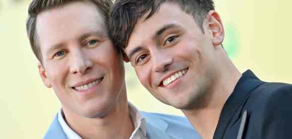 A photo of Dustin Lance Black and Tom Daley posed together