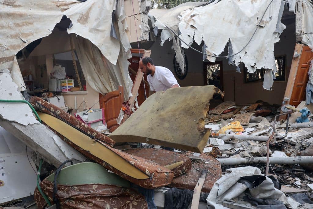 A Palestinian man salvages belongings from the rubble of his house which was destroyed during the latest three days of conflict with Israel ahead of a truce, in Rafah town in the southern Gaza Strip, on August 8, 2022.