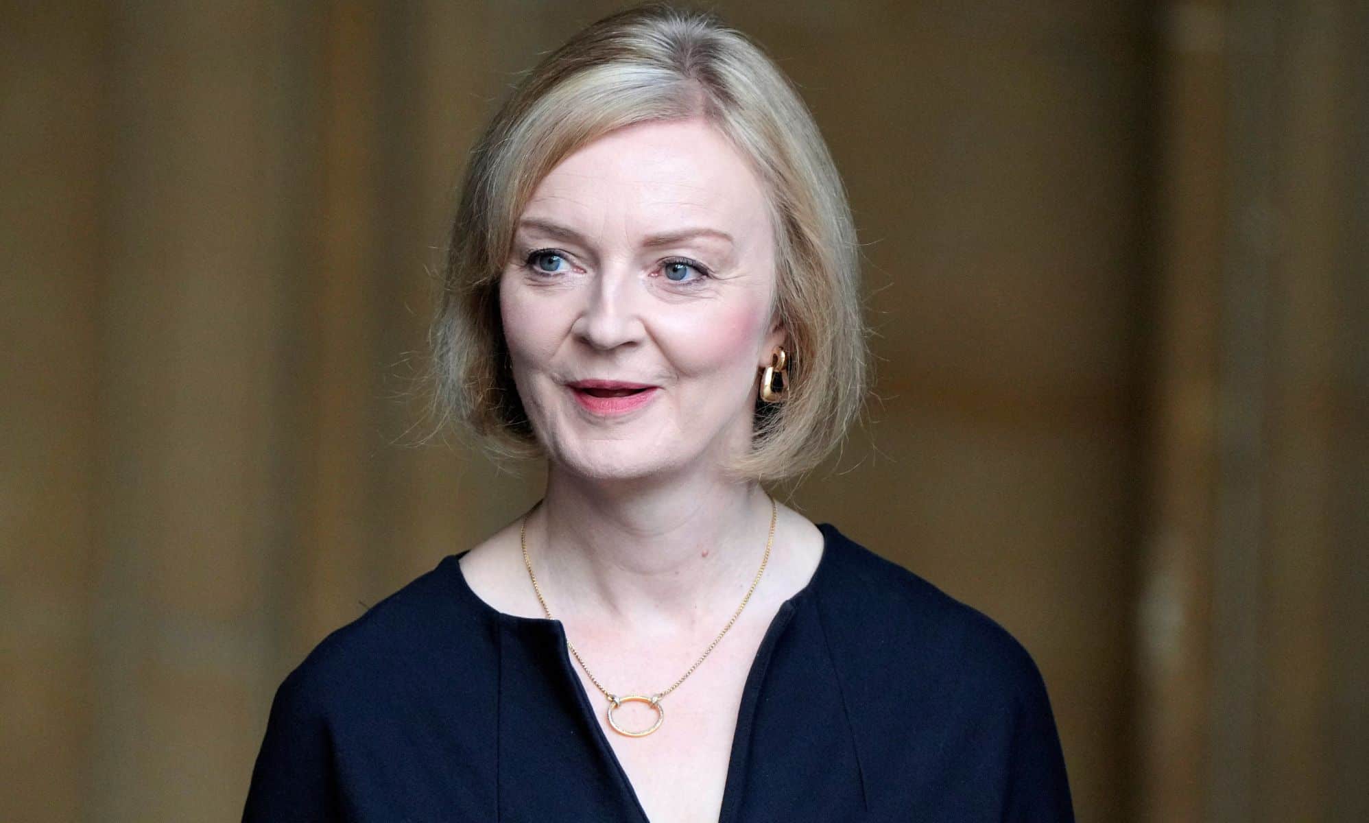 Prime minister Liz Truss is seen wearing a dark blue outfit