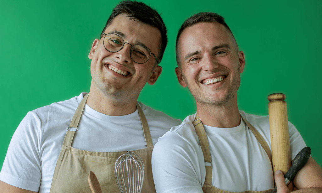 Great British Bake Off stars Michael Chakraverty and David Atherton smile as they pose together