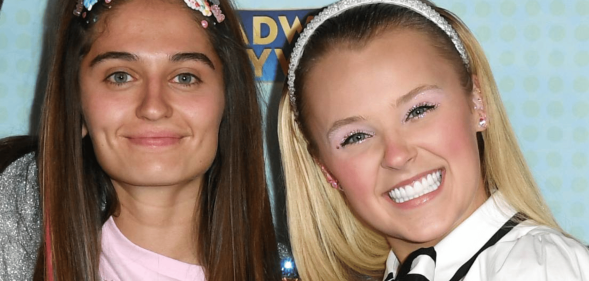 JoJo Siwa smiles for the camera as she stands alongside girlfriend Avery Cyrus