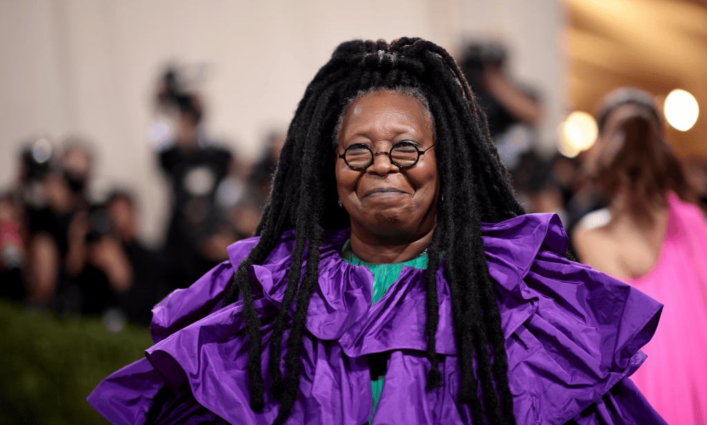 Whoopi Goldberg wears a purple outfit