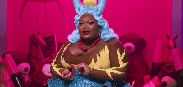 Drag Race star Kornbread Jeté sits during an interview