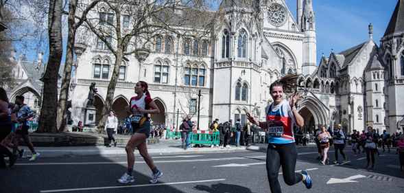 Participants run past The Royal Courts of Justice during the London Landmarks Half Marathon through Westminster and the City.