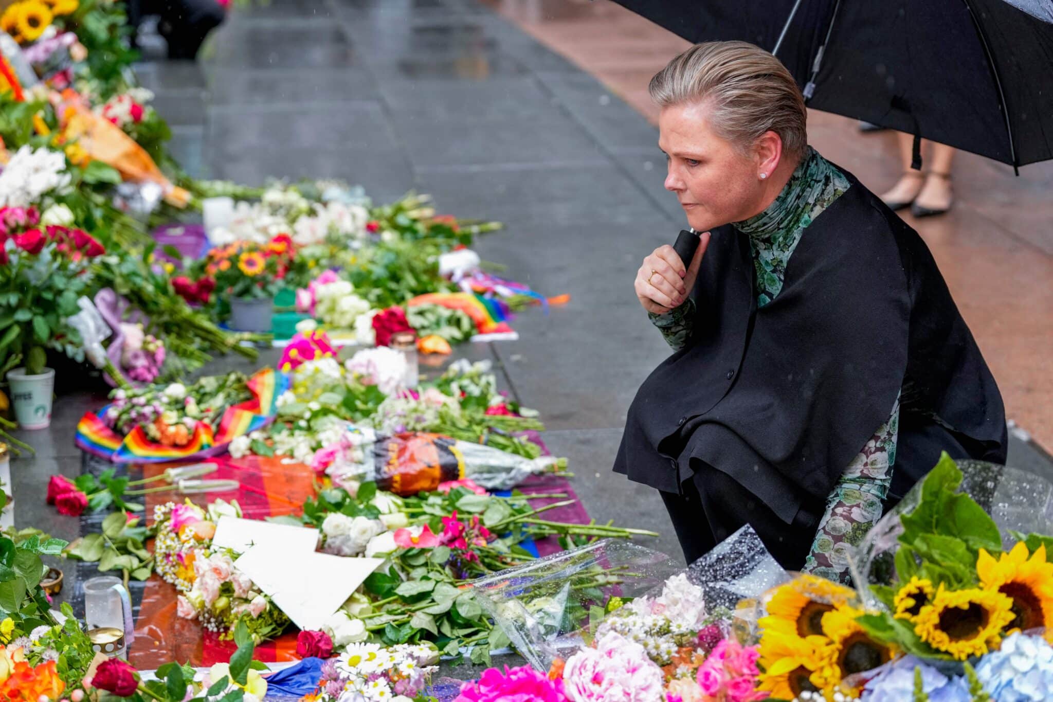 Anne Beathe Tvinnereim, Norway's Minister of International Development, lays flowers at the memorial site where two people where shot in a attack at several LGBTQ+ bars in Oslo, Norway in June 2022