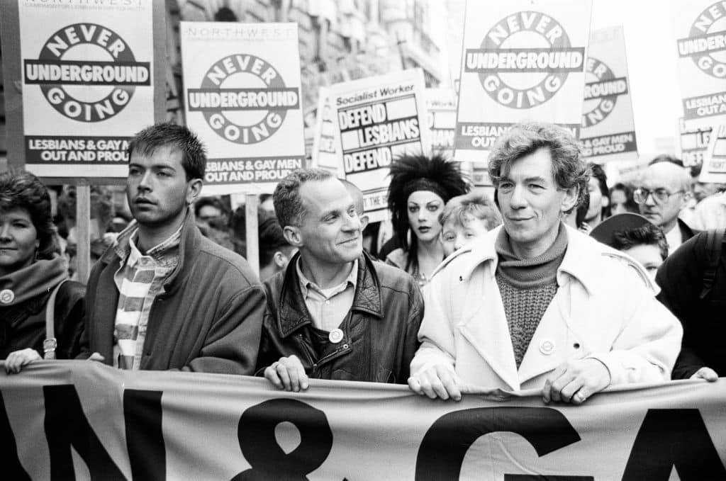 Michael Cashman (C) and Ian McKellen (R) protesting. 