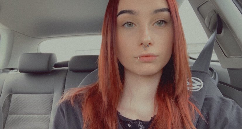 Ilona, a Yungblud fan, pictured wit long red hair and a nose and lip piercing in a car.