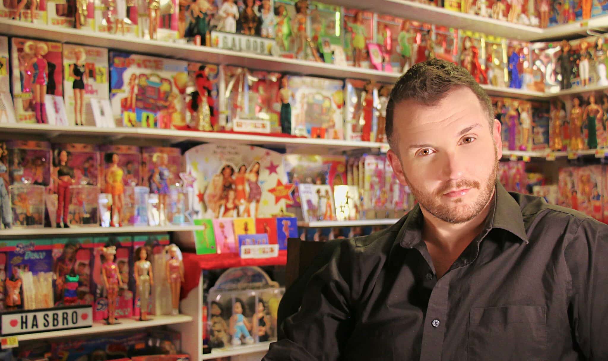 Adam Weatherly with his Spice Girls doll collection in the background. 
