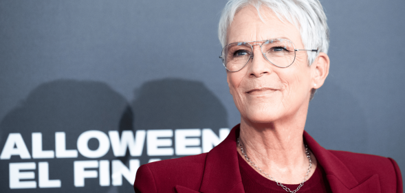 Jamie Lee Curtis wears a red outfit at a press event