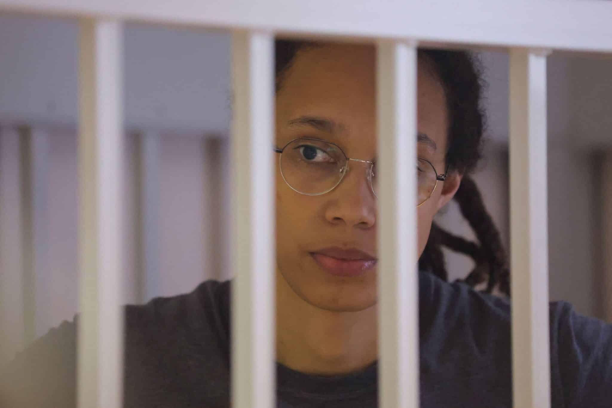 Brittney Griner waits for the verdict inside a defendants' cage during a hearing in Khimki outside Moscow.
