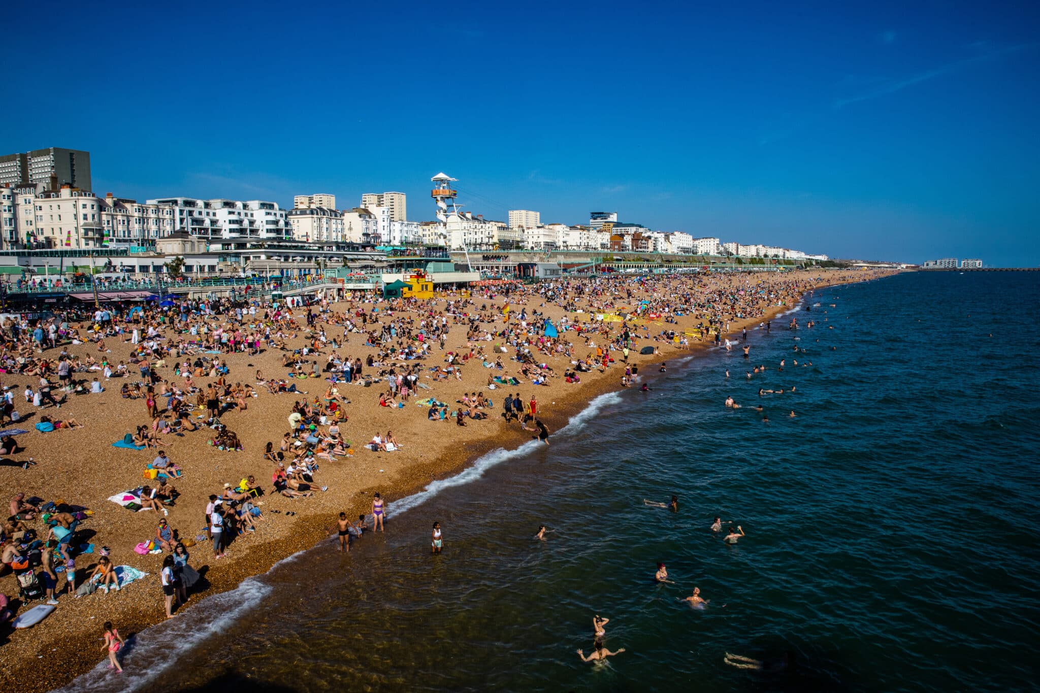 People enjoy the sunshine on Brighton beach during 2022 Brighton pride. 