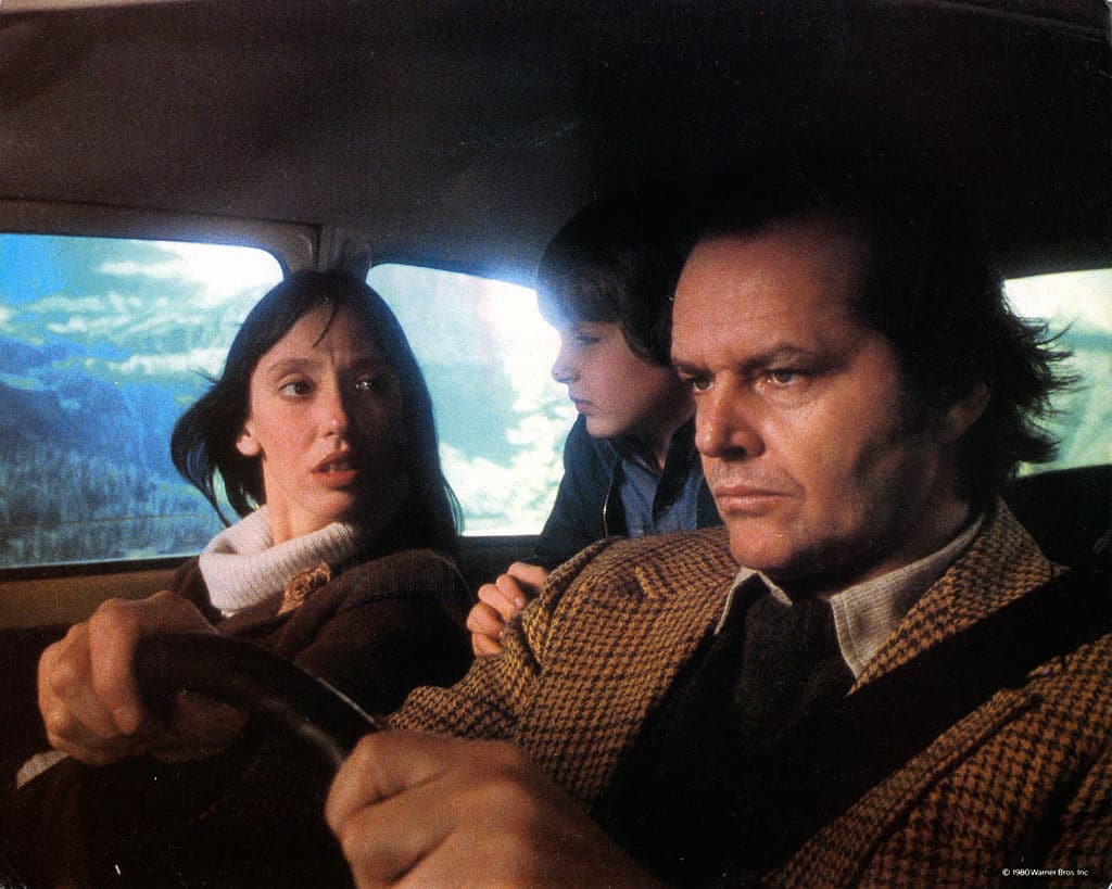 Shelley Duvall, Danny Lloyd, and Jack Nicholson in car on their way to resort in The Shining.
