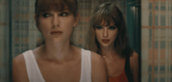 Taylor looking in a mirror with evil Taylor behind her