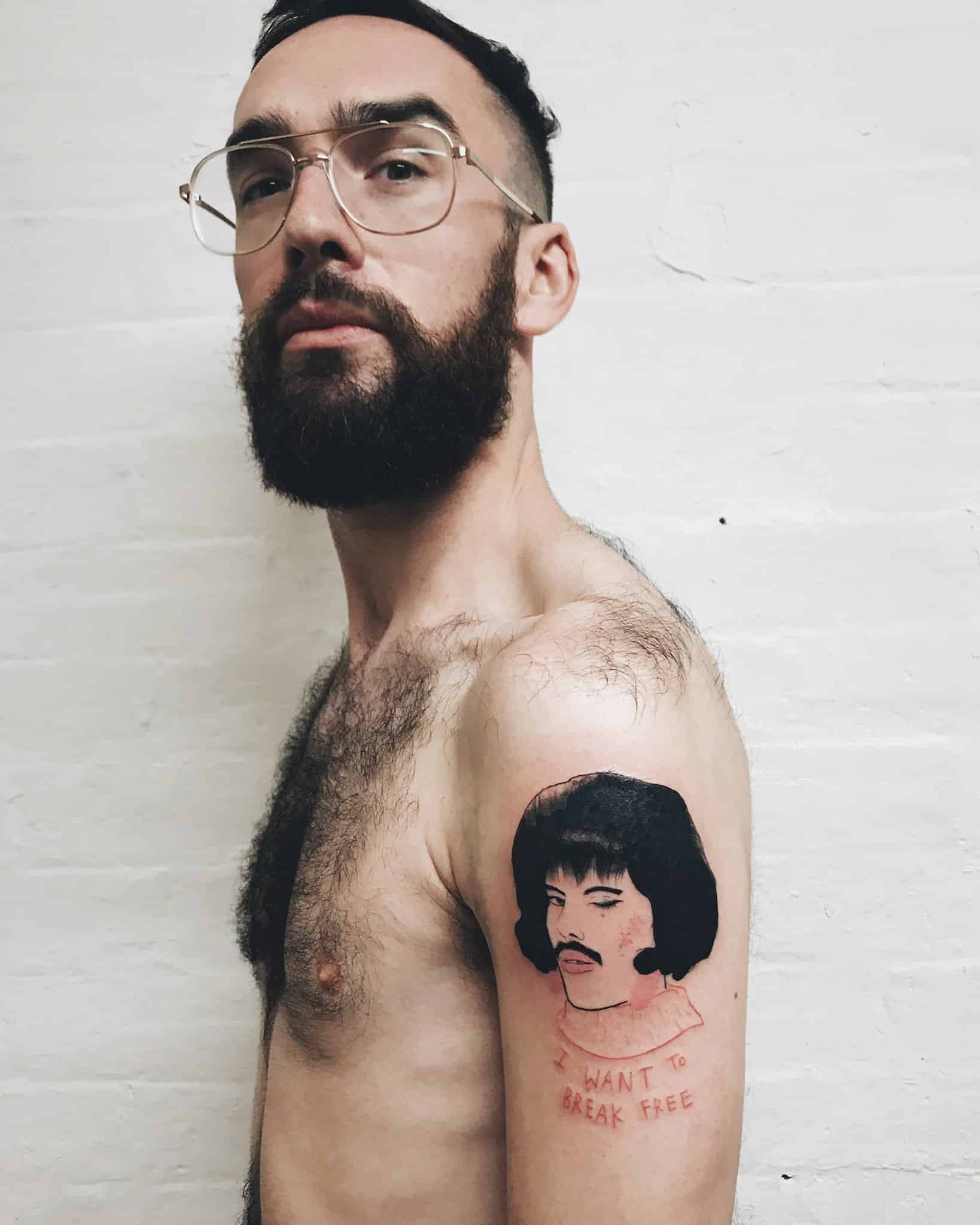 Harry Clayton-Wright showing his Freddie Mercury tattoo, inspired by the I Want To Break Free music video. The tattoo is by the tattoo artist _disinhibition. 