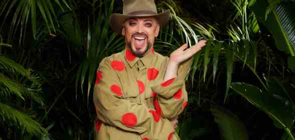 A promo photo of Boy George dressed in his jungle uniform and standing in front of some tropical ferns for the ITV show I'm a Celebrity...Get Me Out of Here! (ITV)