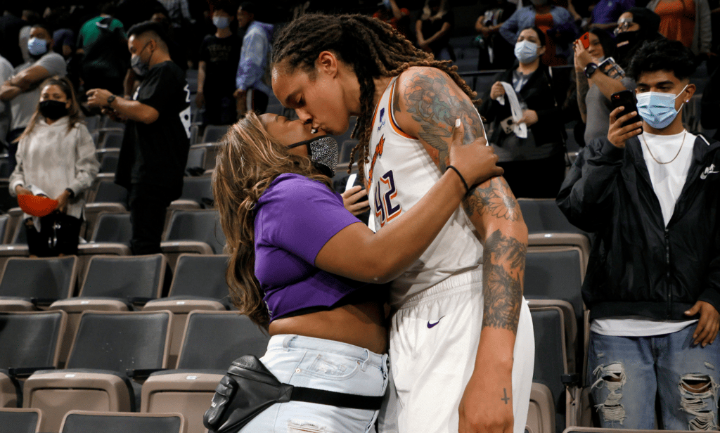Brittney Griner kisses her wife Cherelle Griner in the stands after a basketball game