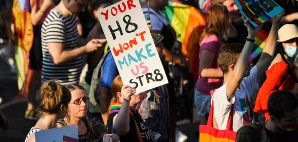 A participant in the equality march in Krakow Poland holds a sign that reads "Your hate won't make us straight"