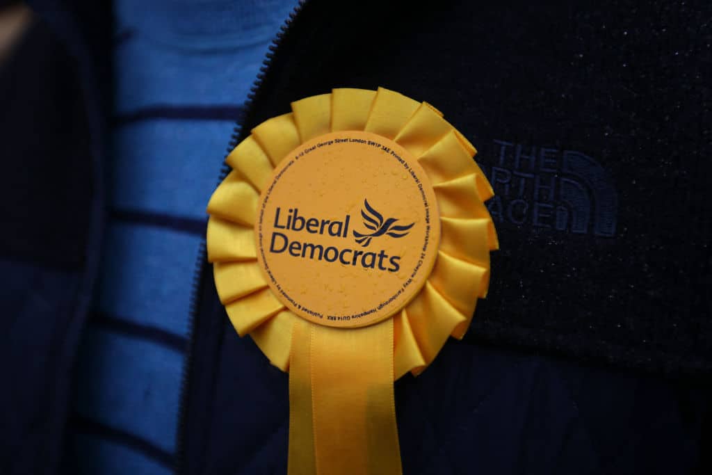 A supporter wears a Liberal Democrats rosette. 