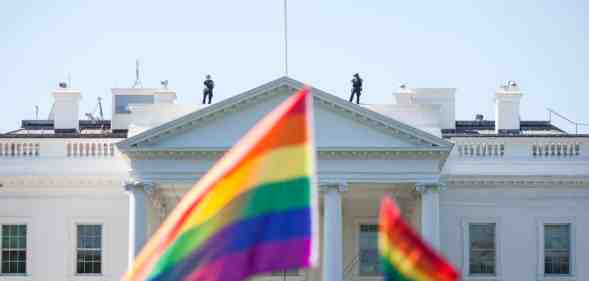 Pride flags are waved in front of the White House.