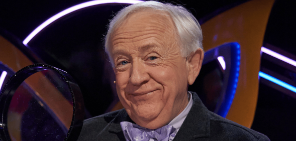 Leslie Jordan holding a magnifying glass on The Masked Singer