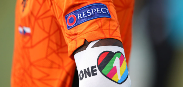 A closeup image of a player's arm from the Netherlands wearing a rainbow OneLove armband