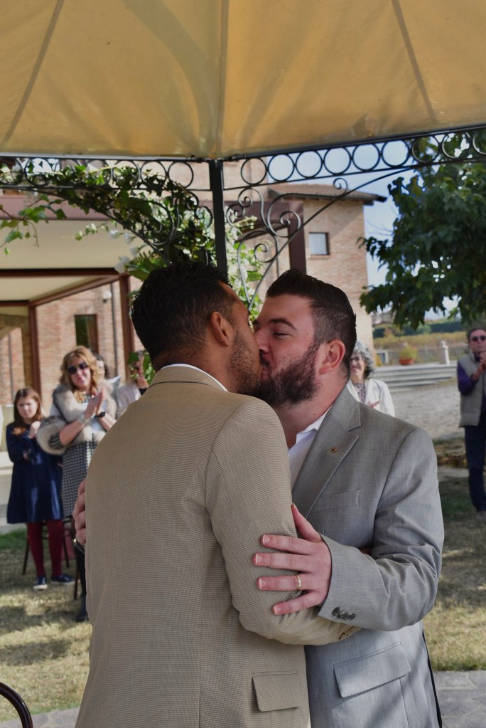Gian Luca Rodrigues Cavallaro kissing his husband Robson on their wedding day. 
