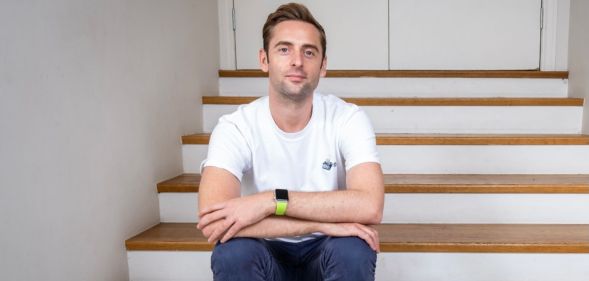 Author Daniel harding wearing white t-shirt, blue jeans, looking at camera with his arms crossed