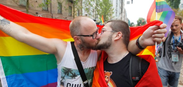 Two men kiss during Kyiv Pride, 2019. (Photo by Pavlo Gonchar/SOPA Images/LightRocket via Getty Images)