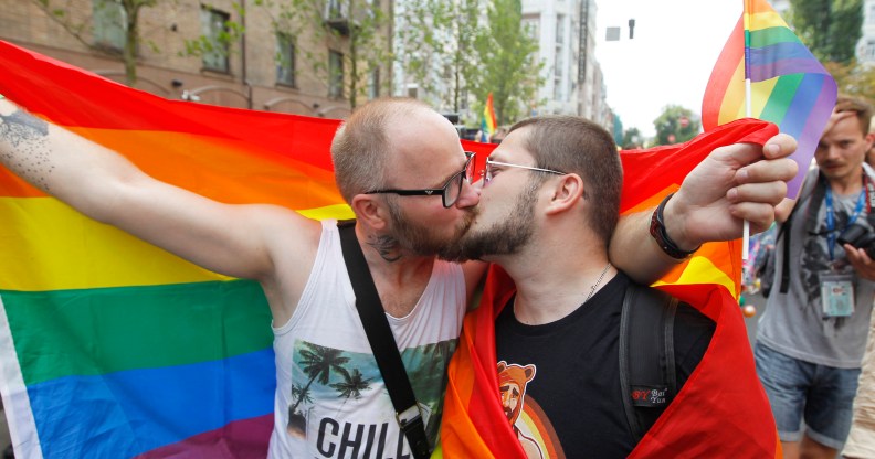 Two men kiss during Kyiv Pride, 2019. (Photo by Pavlo Gonchar/SOPA Images/LightRocket via Getty Images)