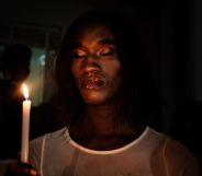 A member of the transgender and LGBTQ community holds candles during the vigil of the Transgender day of Remembrance in order to pay tributes to victims of hate crimes in Uganda and all over the world, in Kampala, Uganda.