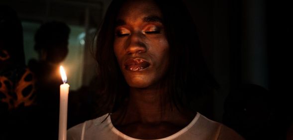 A member of the transgender and LGBTQ community holds candles during the vigil of the Transgender day of Remembrance in order to pay tributes to victims of hate crimes in Uganda and all over the world, in Kampala, Uganda.