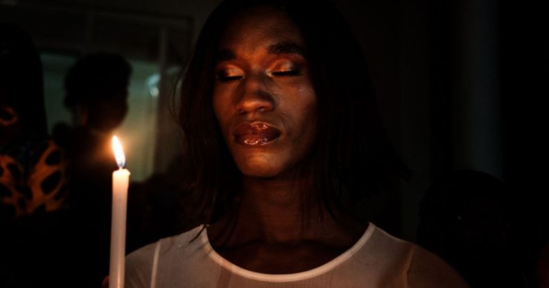 A member of the transgender and LGBTQ community holds candles during the vigil of the Transgender day of Remembrance in order to pay tributes to victims of hate crimes in Uganda and all over the world, in Kampala, Uganda.