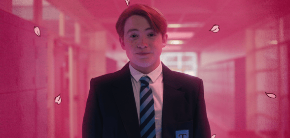 A still from Netflix's Heartstopper which shows Kit Connor as Nick Nelson wearing his school uniform