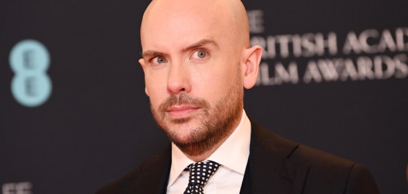 A photo of comedian Tom Allen wearing a black suit, white shirt and black and white patterned tie as he atends the British Academy Film Awards. (Getty)