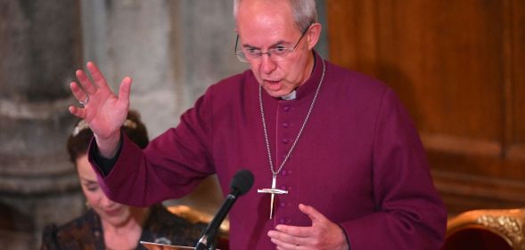 Justin Welby speaks in a purple robe during an event.