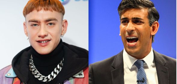 On the left: Olly Alexander in wearing a multicoloured jacket with black roll neck and silver chain against a grey background. On the left, Rishi Sunak talking.