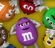 M&Ms characters in a circle surrounding the cartoon purple M&M