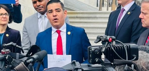 Robert Garcia, surrounded by press, during his speech about aims to expel George Santos.