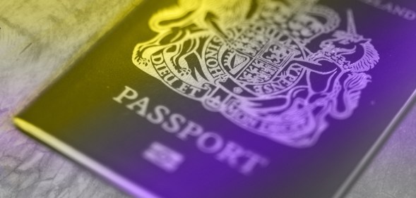 A British passport with the non-binary flag colours washing over it